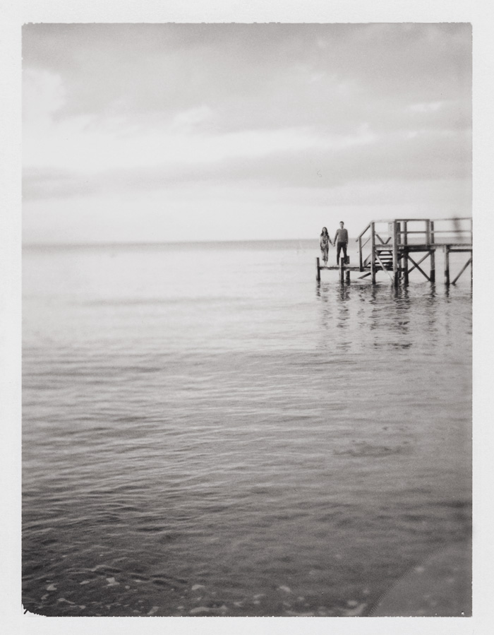 polaroid black and white engagement photography on a jetty
