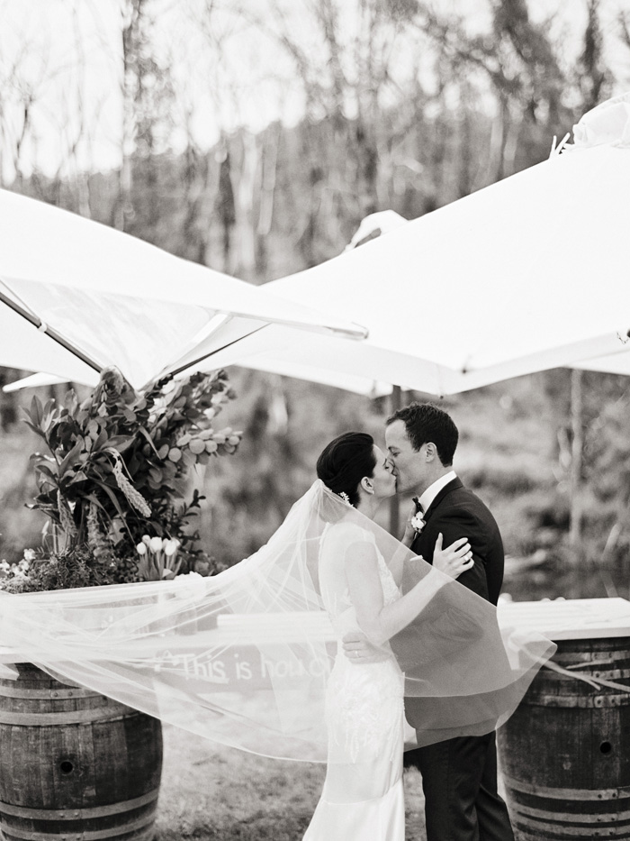 bride and groom kissing at wedding ceremony pronounced husband and wife