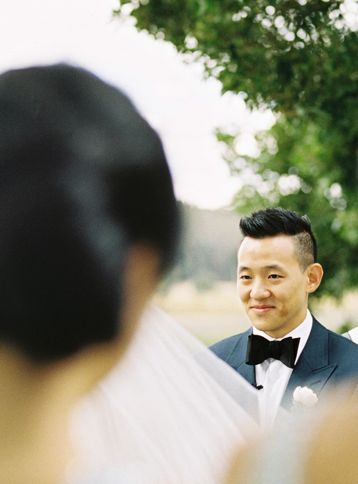 groom at ceremony looking at his bride