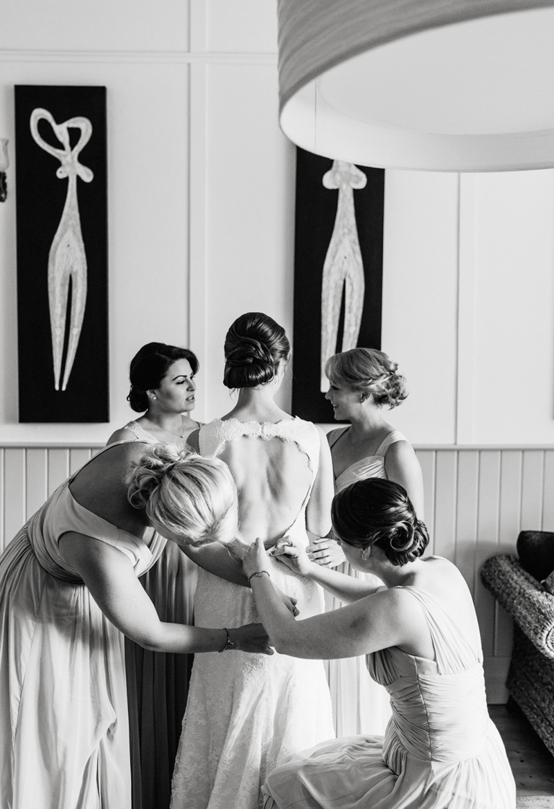 bride getting into wedding gown