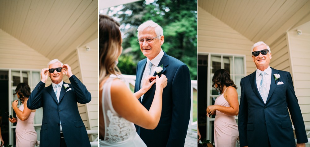 birde and dad putting the flower button hole on