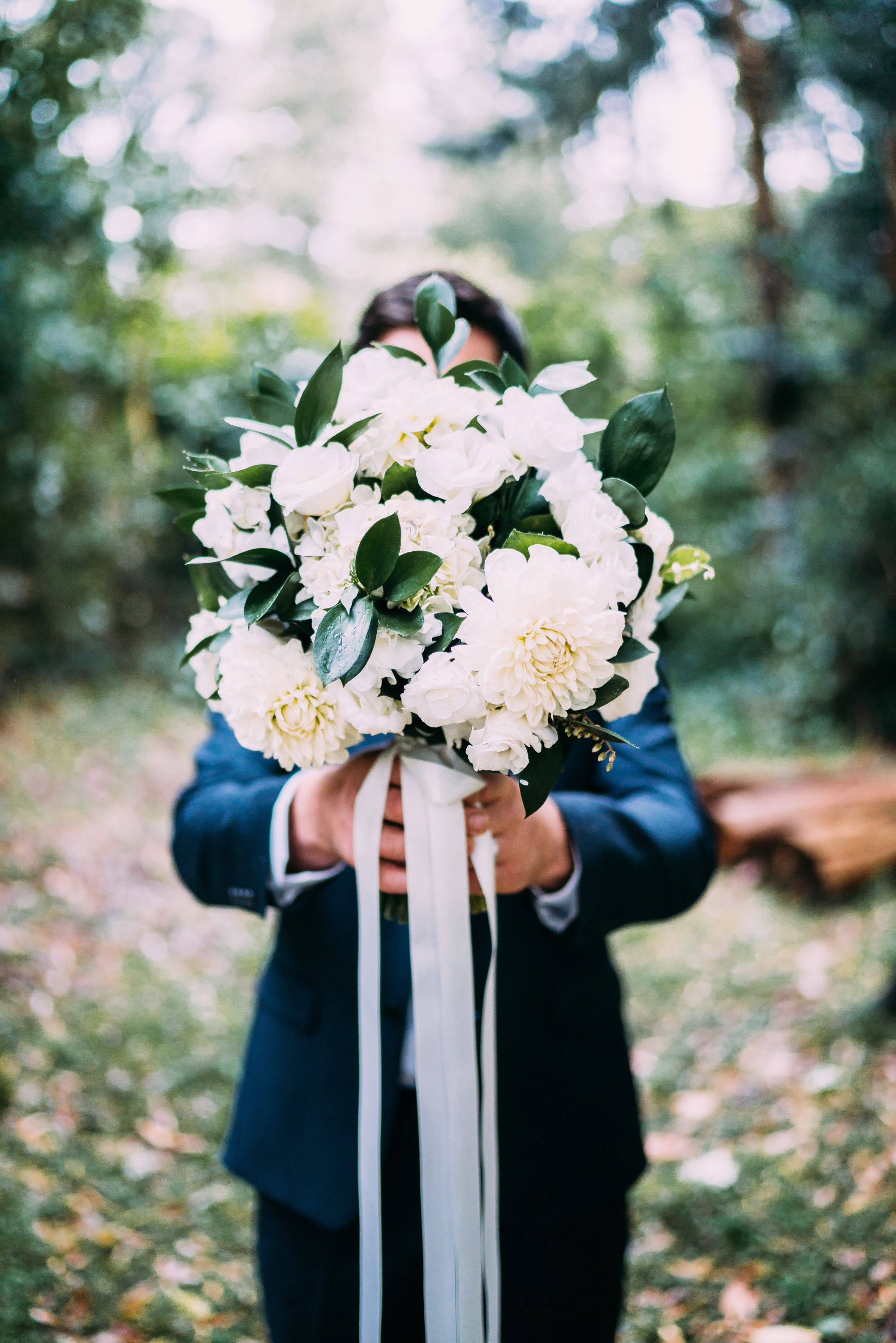 groom holding wedding bouquet 